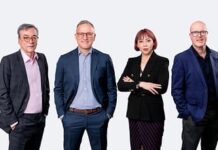 FOR IMMEDIATE RELEASE QNET Announces New Global and African Leadership to Drive Next Phase of Growth in Africa and beyond Group of four business professionals standing side by side against a light backdrop. Two men in suits, a woman in a black blazer, and another man in a blue blazer pose confidently with hands in pockets or arms crossed.