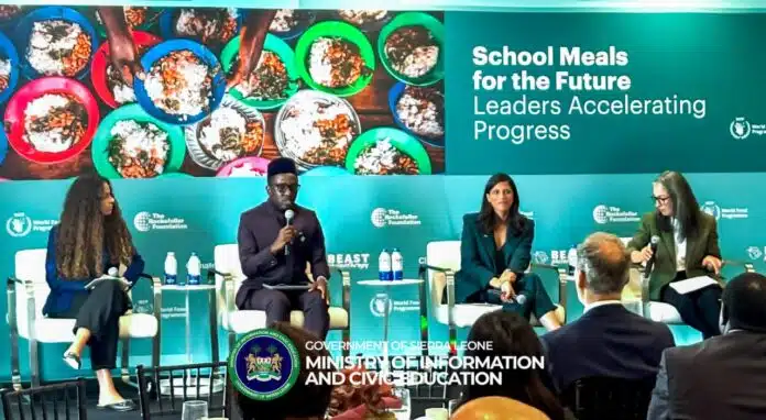 Panel discussion on 'School Meals for the Future: Leaders Accelerating Progress' with four speakers on a turquoise stage and audience in front