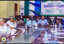 Vice President Wraps Up Decentralization Tour in Port Loko, Pledges Stronger Local Governance Panel of officials seated around a conference table during a regional development forum, with a banner in the background.