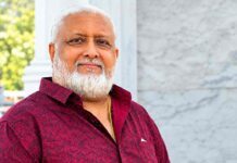 Jolaks Secures $20 Million to Expand Palm Oil Production and Boost Sierra Leone’s Food Security Smiling older man with a white beard in a maroon patterned shirt, standing outdoors near a marble wall.