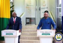 Vice President Hails Productive Engagement with Guinea’s Prime Minister, Engages Over 250 Sierra Leoneans Two officials stand at podiums during a Guinea–Sierra Leone working visit, with national colors in the background.