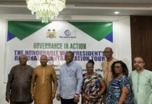 RMFA Wins Widespread Praise for Feeder Road Improvements During Vice President’s Regional Tour Seven people pose for a photo in a conference room in front of a banner that reads Governance in Action at an official event.