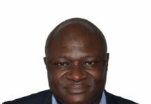 Braima Koroma Puts Sierra Leone on Global Research Map with 2026 Best Paper Award Head-and-shoulders portrait of a smiling man wearing a blue shirt and dark blazer against a white background.