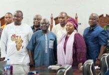 Njala University Opens Three-Day Research Symposium for MPhil and PhD Candidates Group of people standing around a conference table in a meeting room, smiling at the camera.