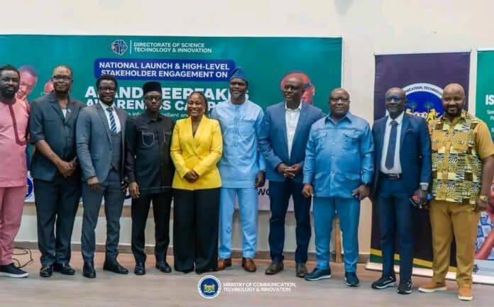 Group of ten people in smart attire posing for a photo at a conference, with banners for the Ministry of Communication, Technology & Innovation in the background.