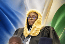 Legal Battle Over 2025 Constitutional Amendment Bill Moves to Supreme Court Three men posing for a portrait: a judge in ceremonial gown and fur wig stands behind two formally dressed men in suits.