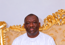 The Wisdom in Hon. Alhaji Musa Tarawally’s Speech: What He Actually Meant Portrait of a man in a white traditional outfit seated on an ornate gold couch with patterned cushions, hands folded in his lap.