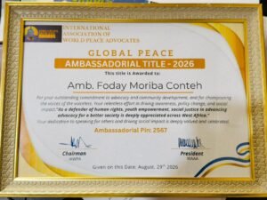 Certificate framed award: Global Peace Ambassadorial Title – 2026, awarded to Amb. Foday Moriba Conteh by the International Association of World Peace Advocates, dated Aug 29, 2026, with signatures.