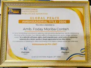 Certificate framed award: Global Peace Ambassadorial Title – 2026, awarded to Amb. Foday Moriba Conteh by the International Association of World Peace Advocates, dated Aug 29, 2026, with signatures.