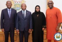 MSM Group Seeks to Unlock Sierra Leone’s Mineral Wealth Through Strategic Investment and Industrial Partnerships Four adults in formal attire pose in an official room, with a crest on the wall behind them and a government seal visible in the corner.