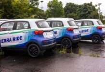 50 Electric Vehicles Set to Hit Freetown Streets as UNDP Advances Youth Employment and Green Mobility Three blue-and-white Sierra Ride SUVs parked in a wet parking lot with green trees in the background.