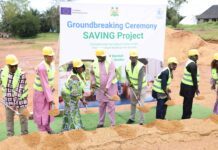 WFP, EU and Government Strengthen Fight Against Child Malnutrition with New Bombali Facility Group of people in yellow hard hats and safety vests shoveling sand at a groundbreaking ceremony in front of a banner reading 'Groundbreaking Ceremony SAVING Project'