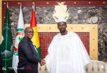 Speaker Segepoh Thomas Strengthens Sierra Leone–Guinea Relations During High-Level Meeting with President Doumbouya Two men shake hands in a formal room with three flags behind them and a crest above the mantle. (Informative: a ceremonial meeting/photo.)