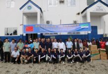CHINA-SIERRA LEONE 55 YEARS OF FRIENDSHIP IN ACTION! China Extends Healthcare Support to Waterloo Communities Group of Chinese and African participants posing in front of a white building with a blue banner about China–Africa friendship, and stacked donation boxes nearby.