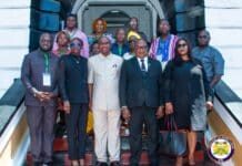Judiciary Engages Liberian Delegation on Proposed War and Economic Crimes Court Group of professionals in business attire posing on a staircase outside a building, with the Judiciary of Sierra Leone emblem visible in the lower right corner.
