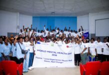 SUCCEED and Partners Urge Greater Support for People Facing Mental Health Challenges Group of people in white shirts pose with a World Mental Health Day 2026 banner in an auditorium, celebrating the event and its theme: Lived Experiences Heard: Real Voices, Real Change.