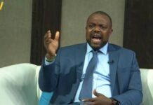 CHRDI Exposes Alleged Inhumane Prison Conditions, Demands Urgent Judicial Reforms and Release of Untried Detainees Man in a blue suit and tie speaks passionately on a TV talk show, gesturing with one hand.
