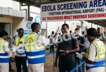 Sierra Leone Heightens Ebola Surveillance at Airport and Borders Following Seven Confirmed Cases in Kenya Airport health screening scene: staff in high-visibility vests measure passengers' temperatures at the Ebola screening area sign, Freetown (FNA).