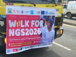 Banner on a yellow truck promoting Walk for NGS2026 with sponsor logos and a photo of a participant.