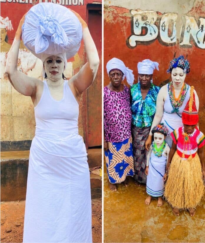 Left: person in white tank top and long skirt balances a large blue bundle on the head, standing before a red wall. Right: group of five in colorful outfits with white face paint, including a child in a grass skirt and red headdress, posing together.